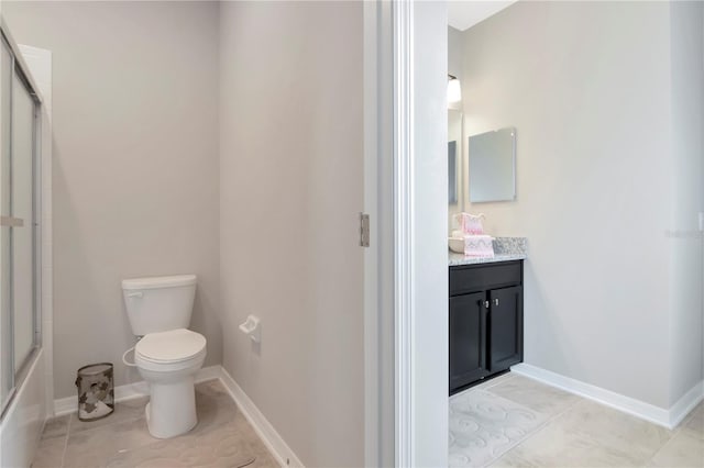 bathroom with tile patterned flooring, vanity, and toilet