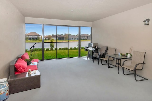 sunroom / solarium with a water view