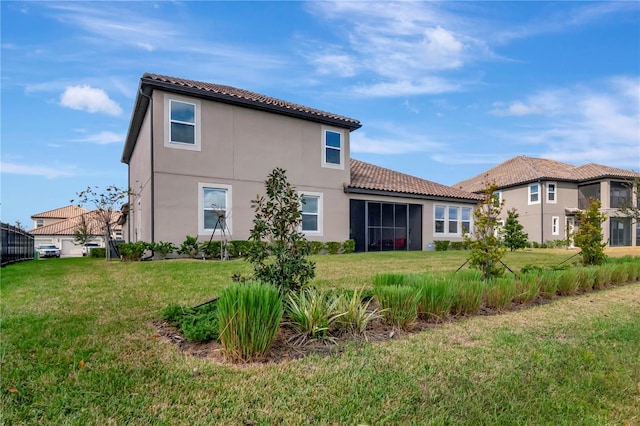 back of property featuring a lawn