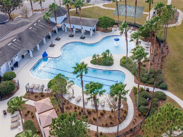 drone / aerial view featuring a community pool and a patio area