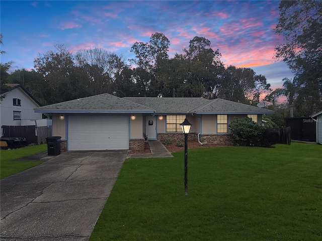 ranch-style home with a lawn and a garage