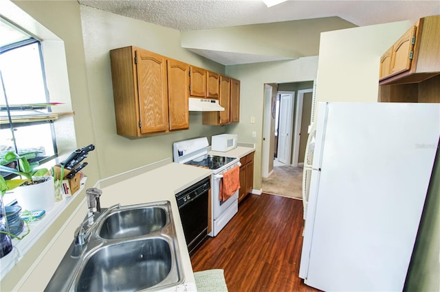 kitchen featuring white appliances, dark wood-type flooring, sink, vaulted ceiling, and a textured ceiling