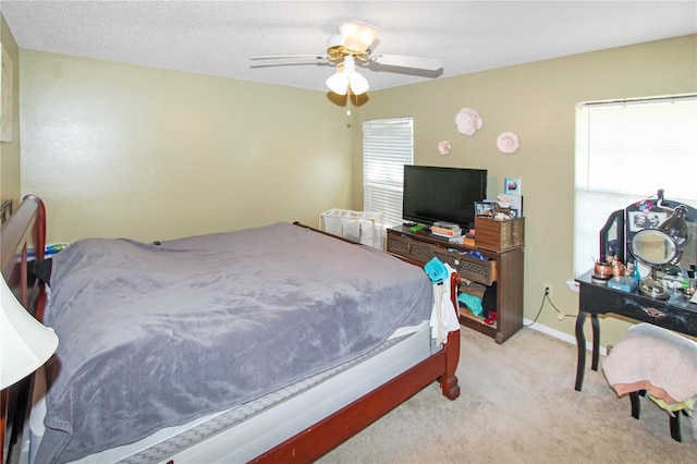 bedroom with ceiling fan and light carpet