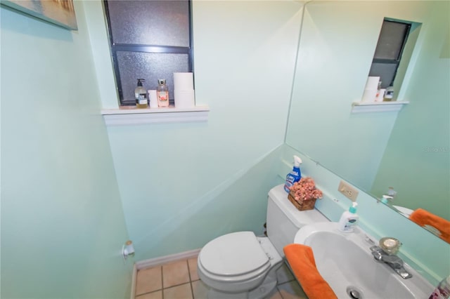 bathroom with tile patterned flooring, toilet, and sink