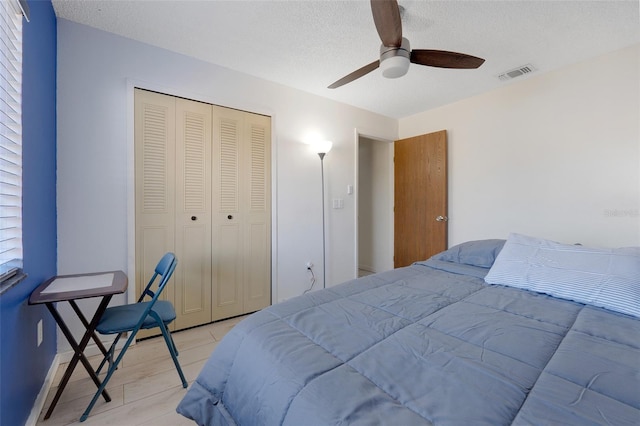 bedroom featuring a textured ceiling, a closet, and ceiling fan