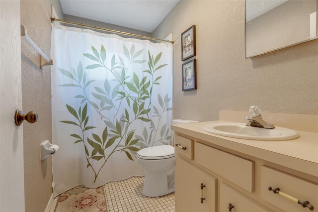 bathroom with a shower with curtain, vanity, a textured ceiling, tile patterned flooring, and toilet