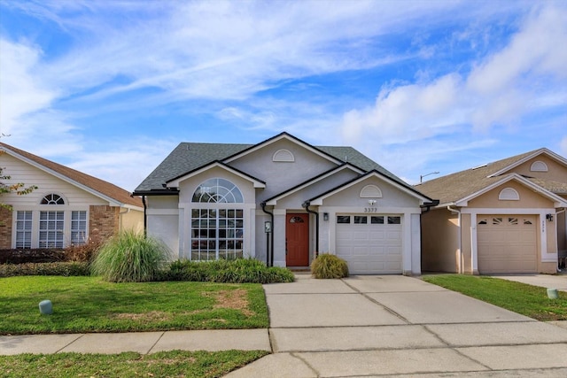 view of front of property featuring a garage and a front yard