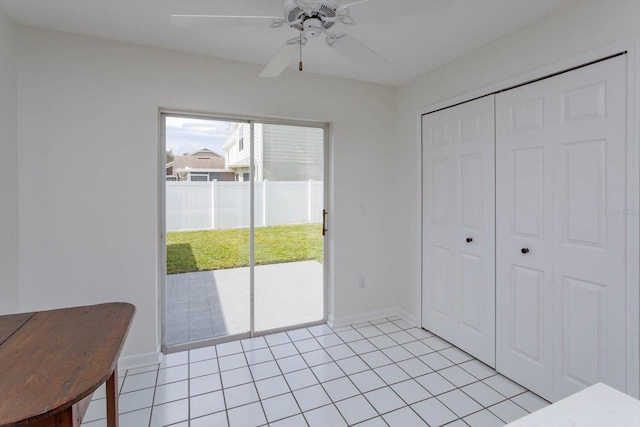 interior space with light tile patterned floors and ceiling fan