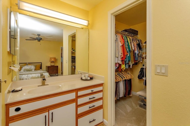 bathroom with ceiling fan and vanity