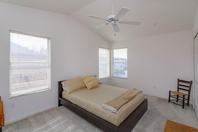 bedroom featuring multiple windows, light colored carpet, ceiling fan, and lofted ceiling