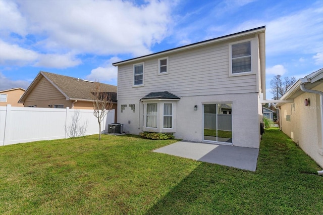 back of property featuring central AC, a patio area, and a lawn