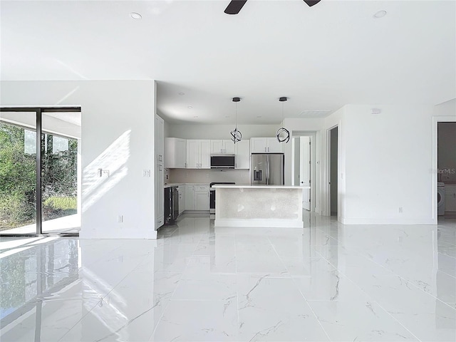 kitchen with pendant lighting, white cabinets, ceiling fan, a kitchen island, and stainless steel appliances