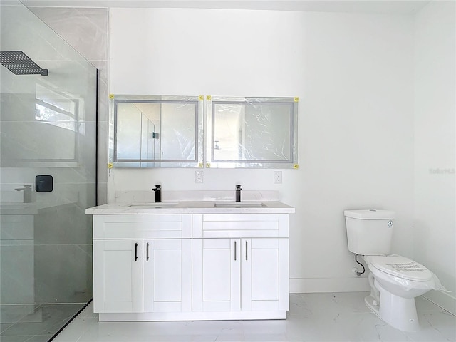 bathroom featuring vanity, a shower with shower door, and toilet