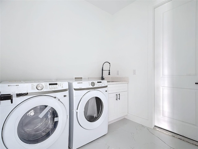 laundry room featuring cabinets, independent washer and dryer, and sink