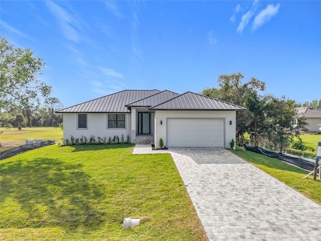 16760 Acapulco Rd, Punta Gorda, FL 33955 - view of front of house featuring stucco siding, an attached garage, decorative driveway, a metal roof, and a standing seam roof