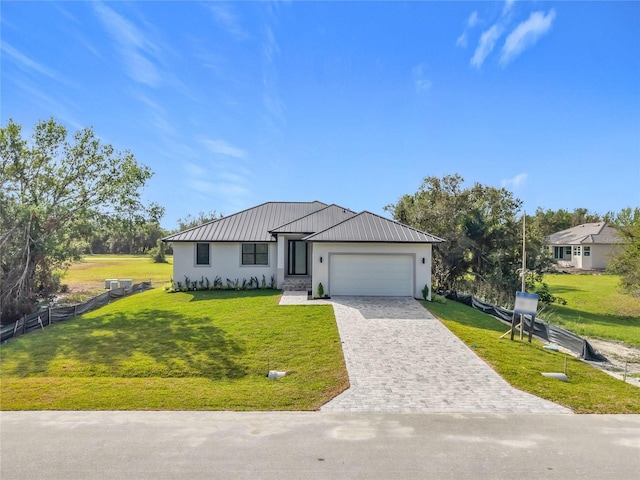 16760 Acapulco Rd, Punta Gorda, FL 33955 - view of front of home featuring decorative driveway, an attached garage, a metal roof, stucco siding, and a standing seam roof