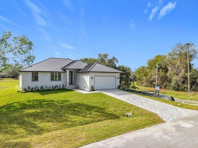 16760 Acapulco Rd, Punta Gorda, FL 33955 - view of front of home with stucco siding, an attached garage, decorative driveway, and a front yard