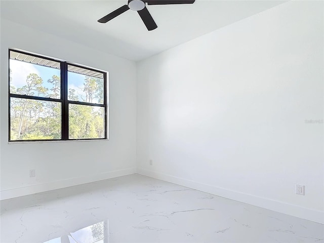 16760 Acapulco Rd, Punta Gorda, FL 33955 - empty room with light marble finish floors and a ceiling fan