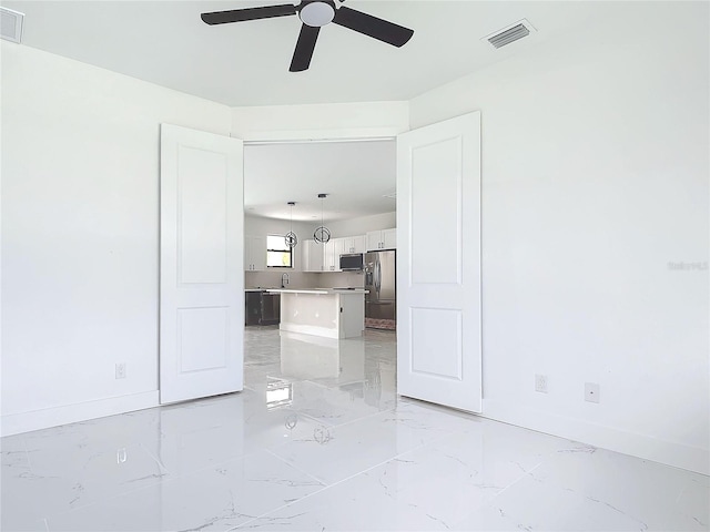 16760 Acapulco Rd, Punta Gorda, FL 33955 - unfurnished living room with light marble finish flooring and ceiling fan