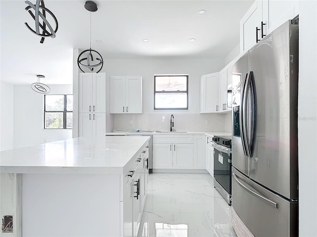 16760 Acapulco Rd, Punta Gorda, FL 33955 - kitchen featuring stainless steel fridge with ice dispenser, range, healthy amount of natural light, a center island, and recessed lighting