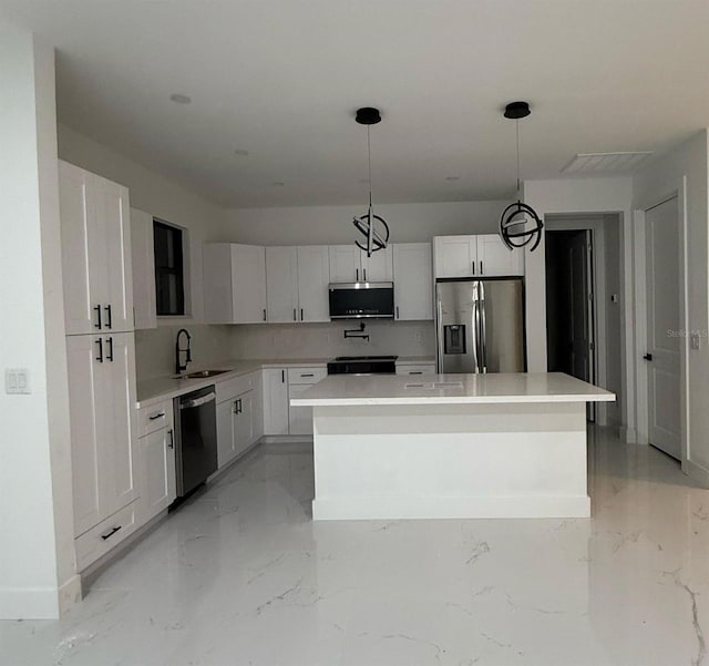 16760 Acapulco Rd, Punta Gorda, FL 33955 - kitchen featuring stainless steel appliances, a center island, white cabinets, and light countertops