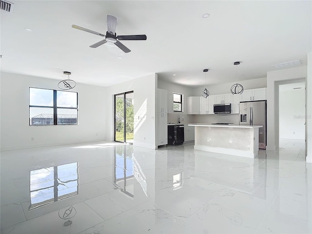 16760 Acapulco Rd, Punta Gorda, FL 33955 - unfurnished living room featuring light marble finish floors, a ceiling fan, and recessed lighting