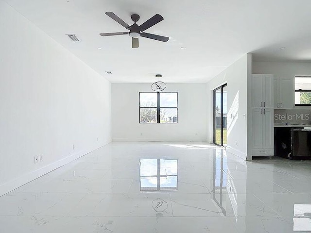16760 Acapulco Rd, Punta Gorda, FL 33955 - unfurnished room with light marble finish floors and ceiling fan