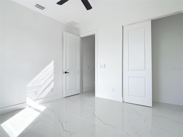16760 Acapulco Rd, Punta Gorda, FL 33955 - unfurnished bedroom with light marble finish floors and ceiling fan