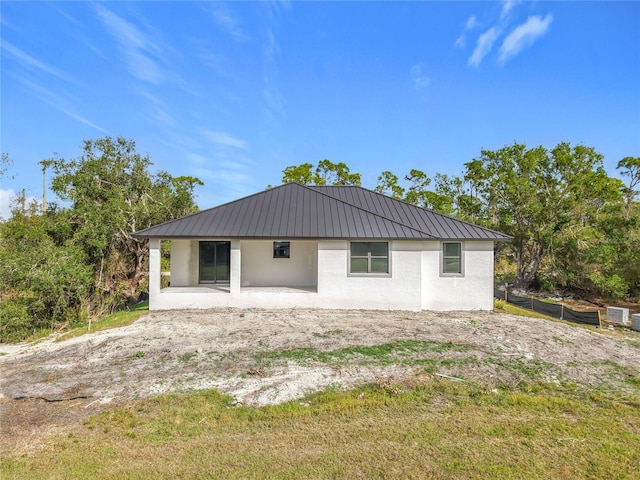 16760 Acapulco Rd, Punta Gorda, FL 33955 - back of house with a metal roof and stucco siding