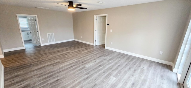 empty room featuring ceiling fan and light wood-type flooring