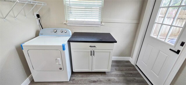 washroom featuring cabinets, washer / dryer, dark hardwood / wood-style flooring, and a wealth of natural light