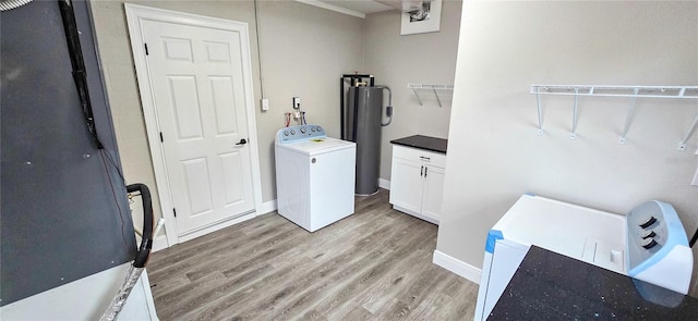 clothes washing area featuring cabinets, light wood-type flooring, and washer / dryer