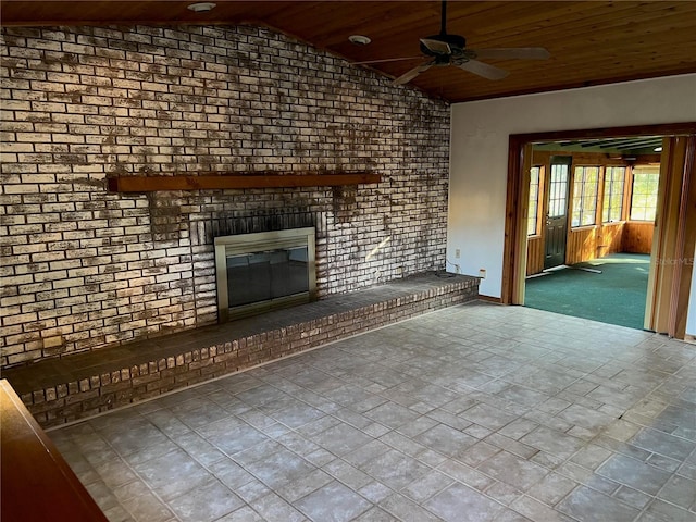 unfurnished living room with a fireplace, lofted ceiling, ceiling fan, and wooden ceiling