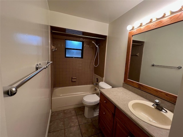 full bathroom with tile patterned flooring, tiled shower / bath combo, toilet, and vanity