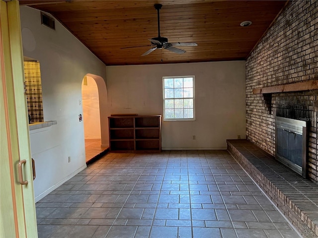 unfurnished living room with ceiling fan, lofted ceiling, a fireplace, and wooden ceiling