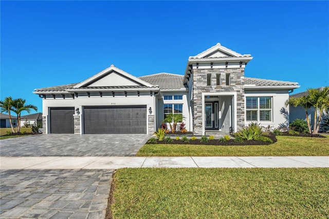 view of front of house with a garage and a front yard