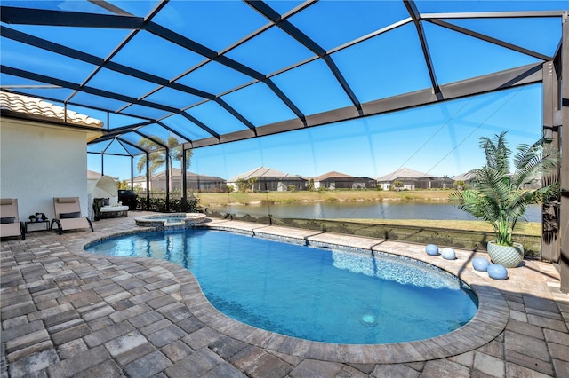 view of pool featuring an in ground hot tub, a lanai, a water view, and a patio area