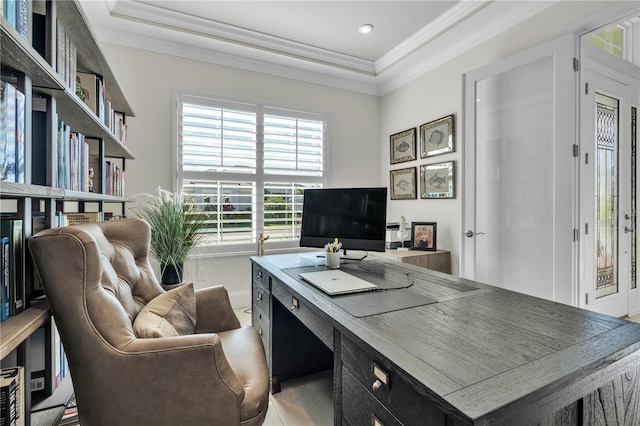 tiled office space with crown molding and a raised ceiling