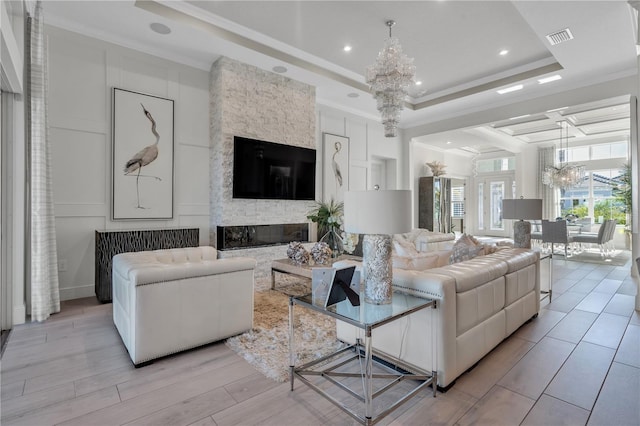 living room with ornamental molding and a notable chandelier