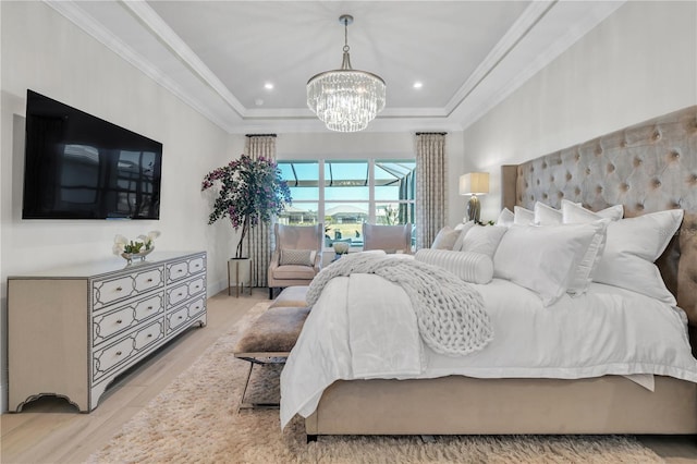 bedroom featuring a chandelier, crown molding, and light hardwood / wood-style floors