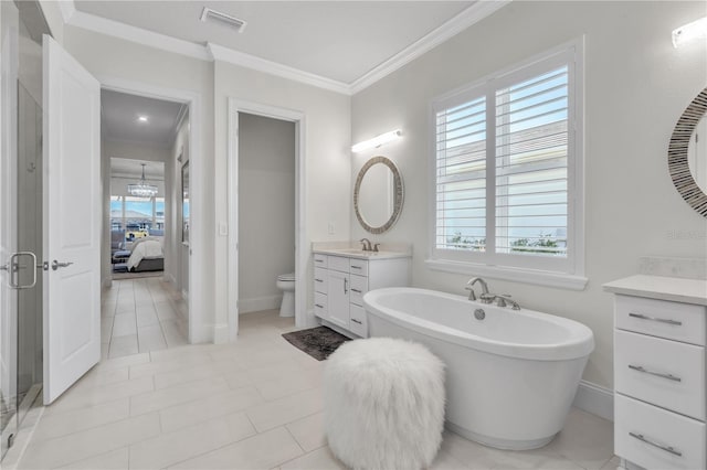 bathroom with a healthy amount of sunlight, a bathtub, vanity, and ornamental molding