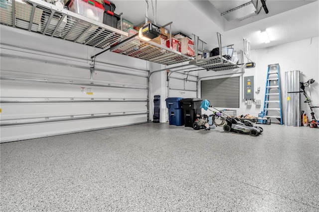 garage with a garage door opener and electric panel