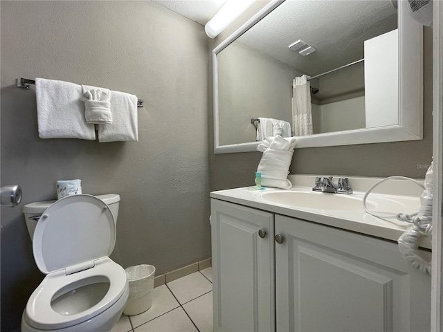 bathroom featuring a textured ceiling, vanity, a shower with shower curtain, and tile patterned flooring