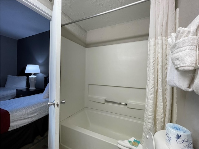 bathroom featuring shower / bath combo with shower curtain and a textured ceiling