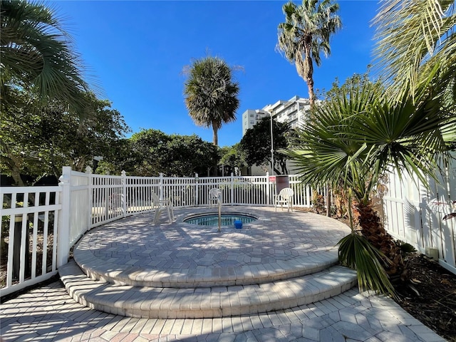 view of swimming pool with an in ground hot tub