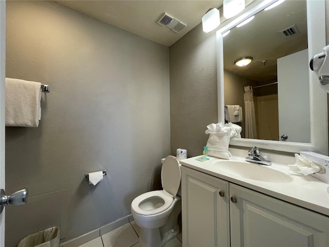 bathroom with toilet, vanity, tile patterned flooring, and a shower with curtain