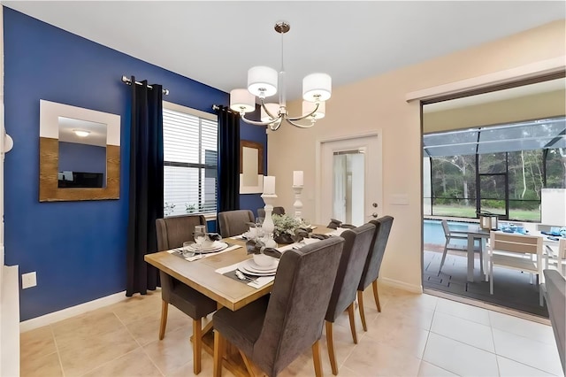 tiled dining room with a notable chandelier