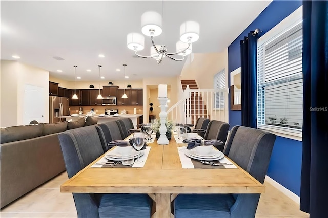 tiled dining room with a notable chandelier