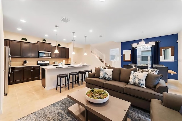 tiled living room featuring a notable chandelier