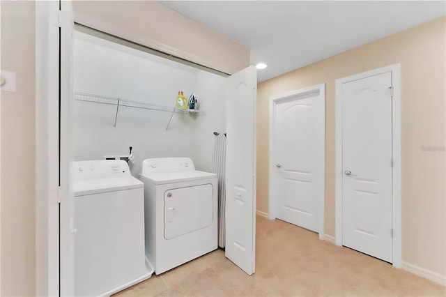 laundry room featuring light carpet and independent washer and dryer